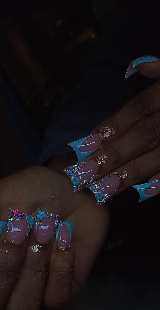 Stunning Soft Pink and Vibrant Blue Nail Design with Colorful Gems and Floral Accents for a Bold Statement.