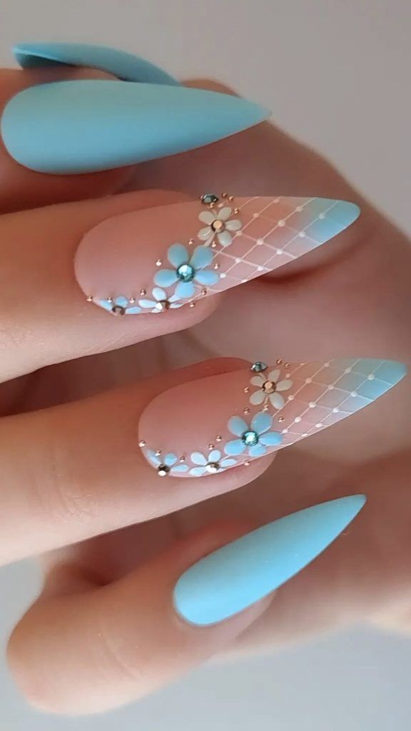 Elegant Matte Nail Design: Soft Blue and Nude with Intricate Floral Patterns and Delicate Embellishments.