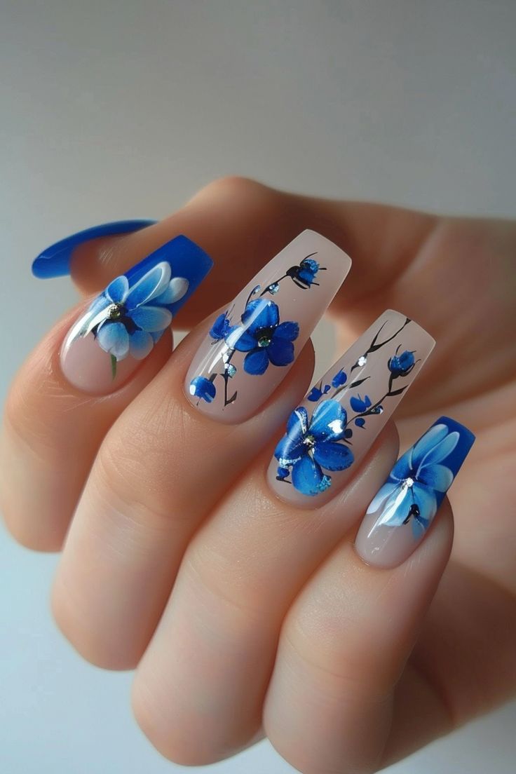 Elegant Floral Nail Design with Delicate Blue Flowers on a Neutral Base