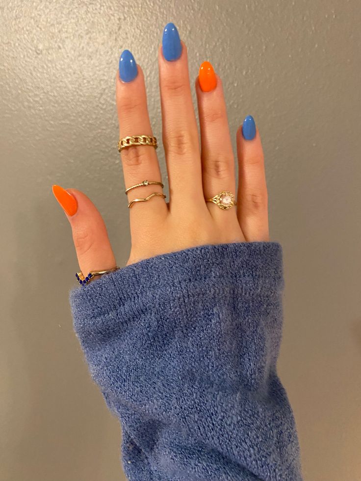 Vibrant Orange and Soft Blue Almond Nail Design: A Modern, Fun, and Elegant Look.