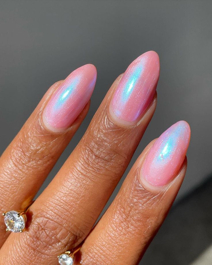 Chic Almond-Shaped Pink Ombre Nails with Iridescent Shimmer for Any Occasion.