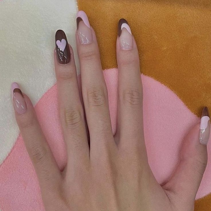 Trendy Almond-Shaped Nail Design Blending Soft Pink and Rich Brown with Playful Heart Accents.