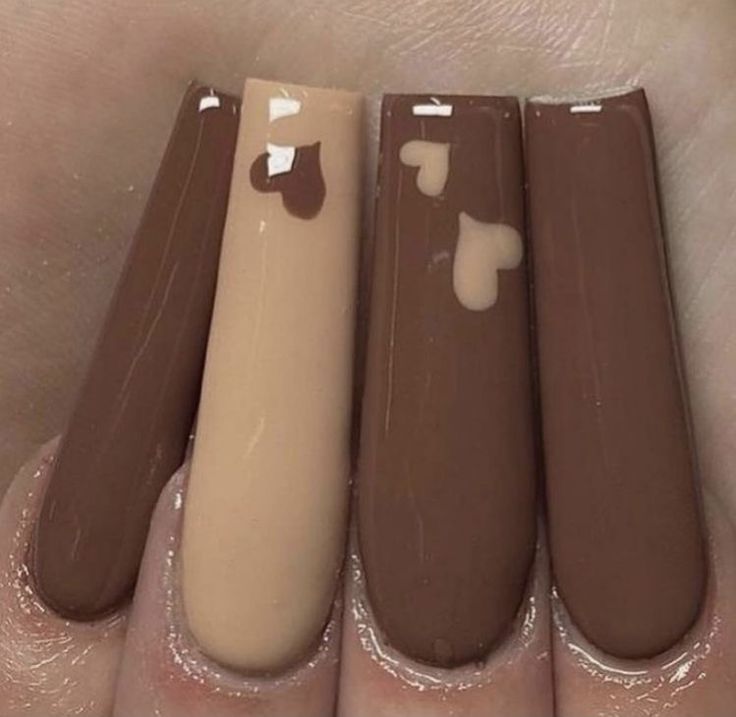 Stylish Gradient Brown Nail Design with Playful Heart Accents.