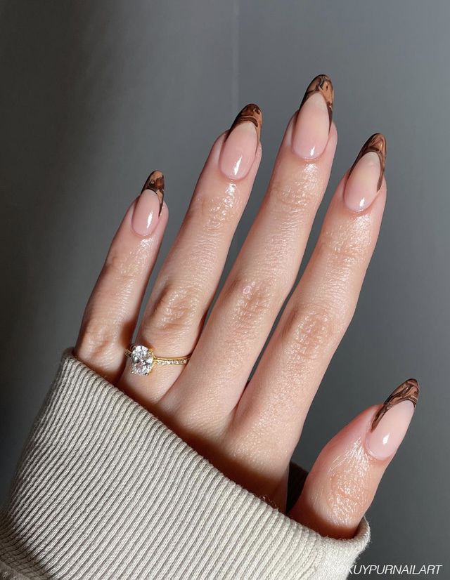 Chic Almond-Shaped Nails: Elegant Nude Base with Bold Marbled Brown Tips