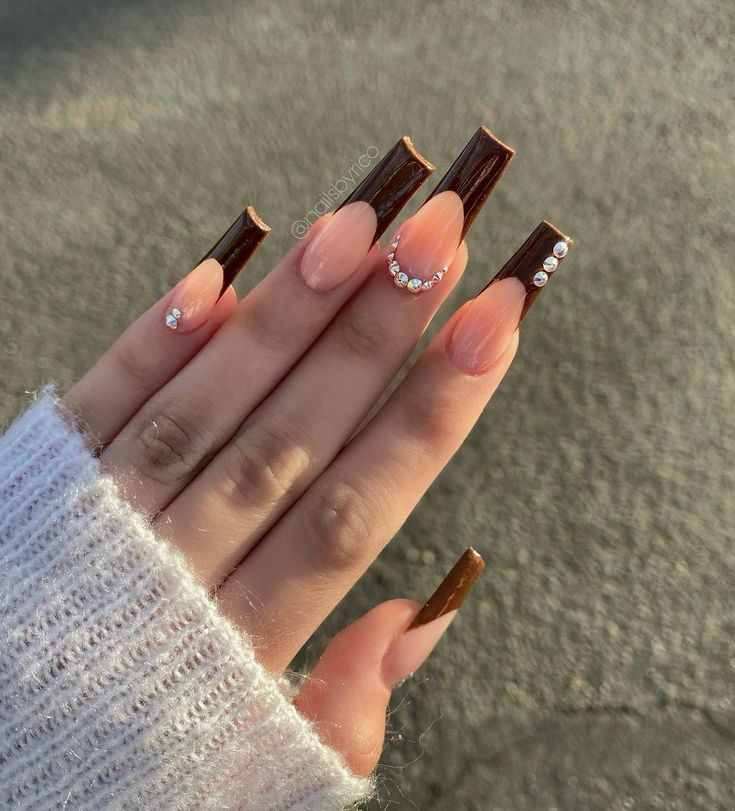 Chic Nail Design: Elegant Nude and Brown Ombre with Glossy Chocolate Tips and Sparkling Crystal Accents.