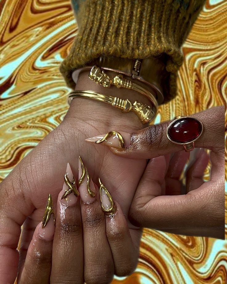 Sophisticated Nail Design with Elongated Shapes and Striking Gold Accents