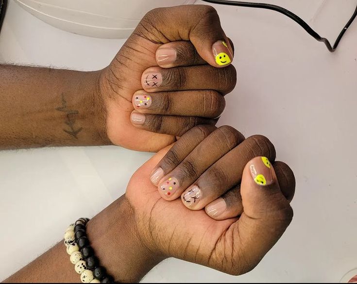 Cheerful Playful Nail Designs with Smiley Faces and Quirky X Motifs