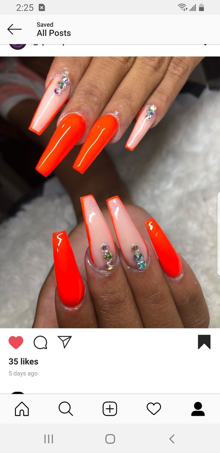 Vibrant Orange Bold Nail Design with Glossy Finish and Rhinestone Accents.