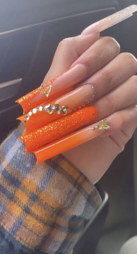 Striking Vibrant Orange Coffin Nails with Glitter and Gold Accents