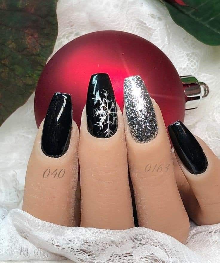 Chic Winter-Inspired Nail Design: Glossy Black, Sparkling Silver, and Intricate Snowflakes.