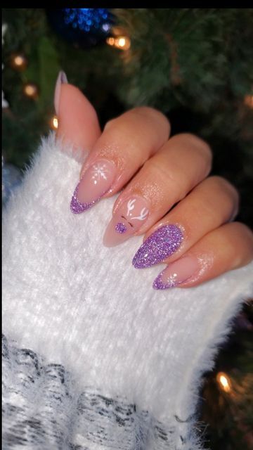 Festive Sparkling Nail Design: Elegant Pale Pink and Purple with Glittery Accents and Whimsical Holiday Motifs.