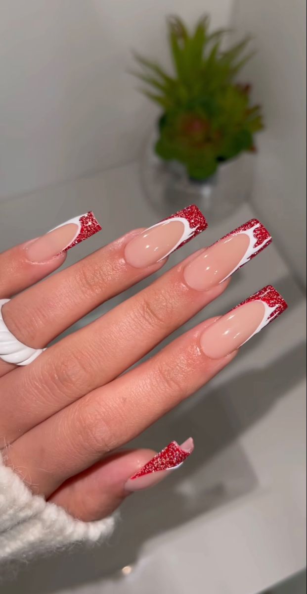 Chic Nail Design: Nude Base with Glittery Red Tips and Sophisticated White Accents