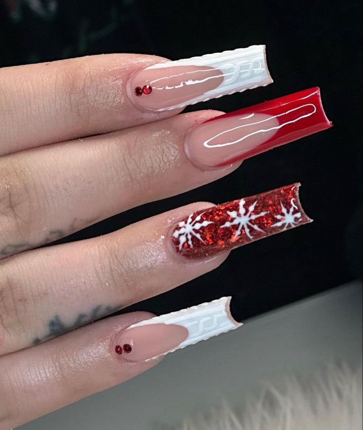 Festive Bold Nail Design with Red, White, Glitter Accents, and Snowflake Patterns.