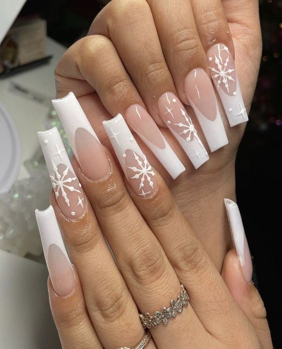 Chic Winter-Inspired Nail Art with Snowflake Patterns and Geometric Shapes.