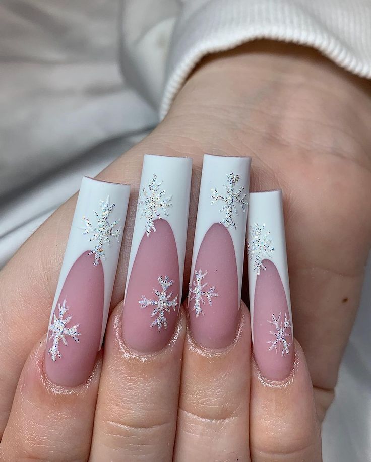 Elegant Winter Nail Design: Matte Pink and Glossy White with Intricate Snowflake Embellishments.