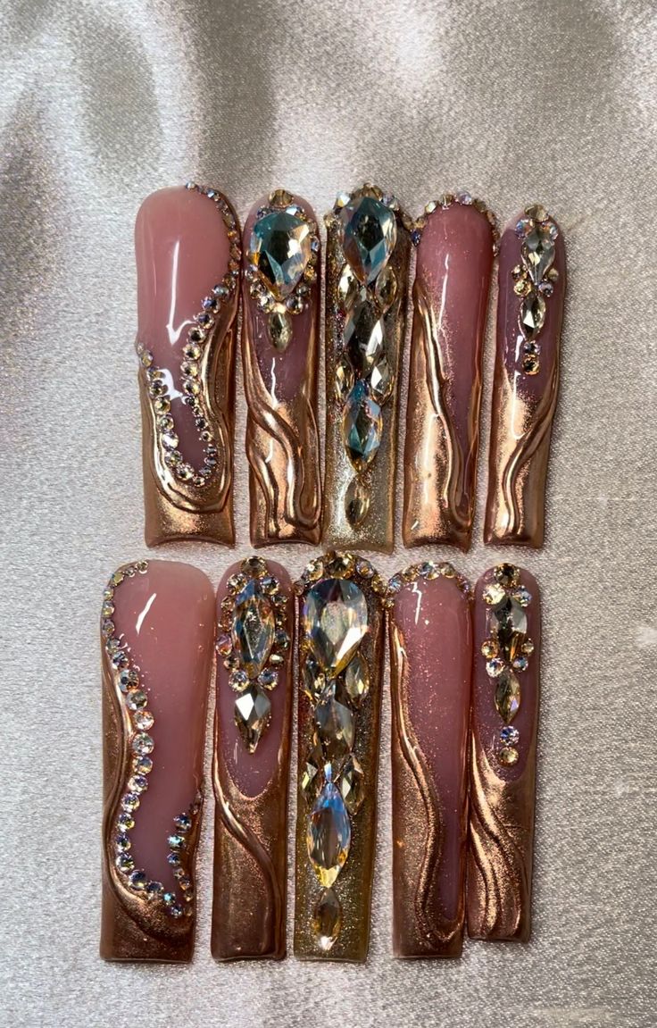 Luxurious Nail Design: Soft Pink & Metallic Gold with Intricate Embellishments