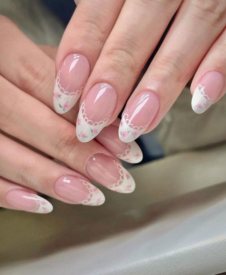 Elegant Floral Nail Design: Soft Pink Base with White Tips and Lace Accents.