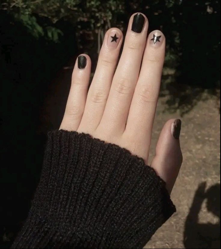 Chic Black Nail Design with Star Accents: A Versatile Statement Look