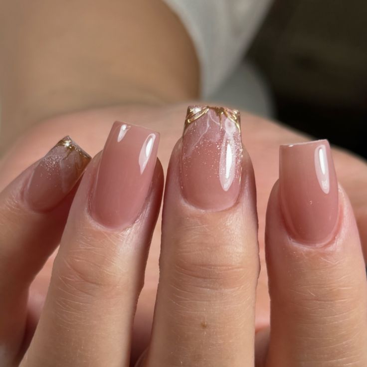 Chic Elegant Nude Nails with Subtle Gradient and Metallic Accents.