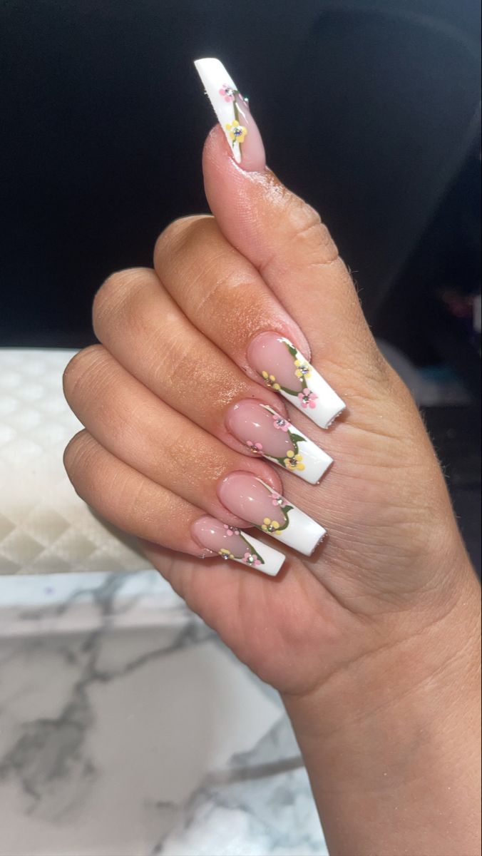 Chic Long White Tip Nails with Glossy Finish and Floral Accents.