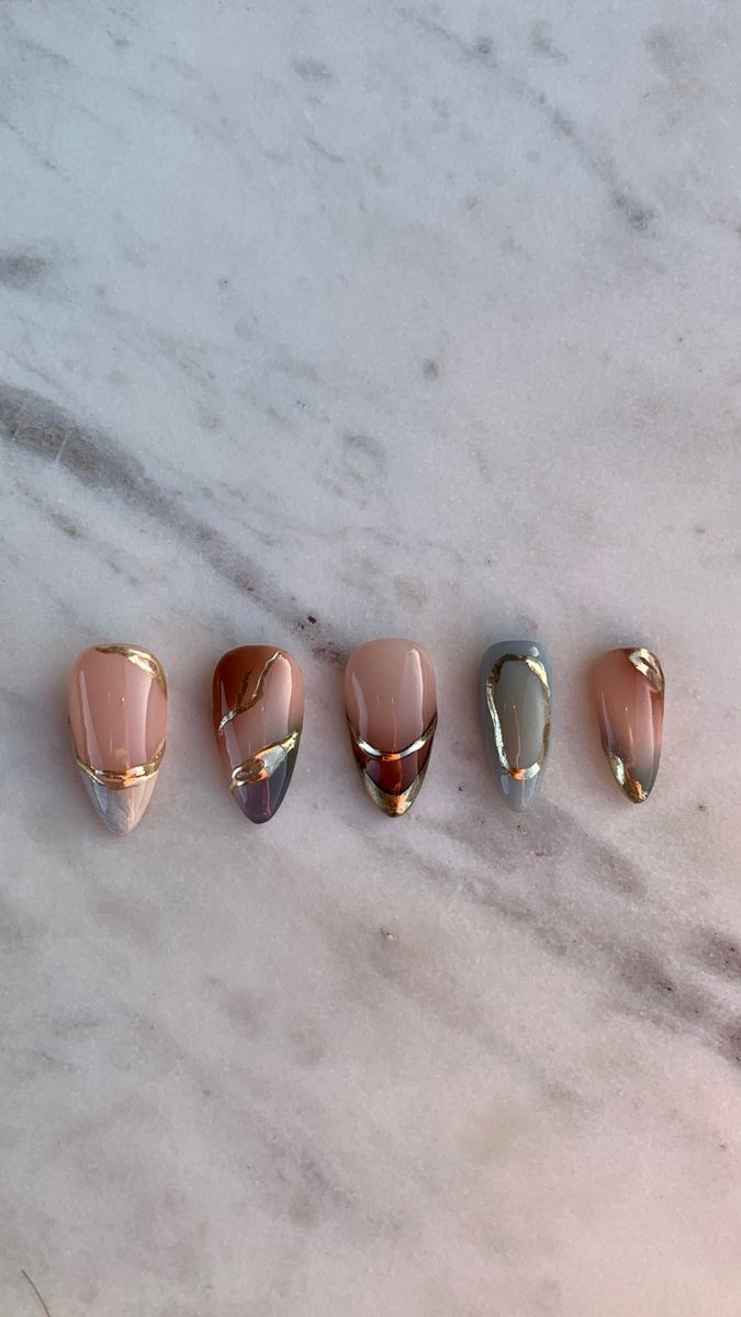 Sophisticated Pastel Nail Design with Shimmering Metallic Accents and Luxurious Gold Lines.