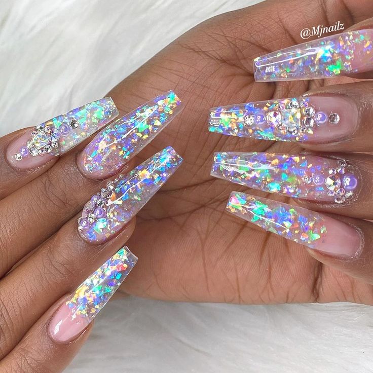 Glamorous Iridescent Stiletto Nail Design with Glitter and Gemstone Embellishments