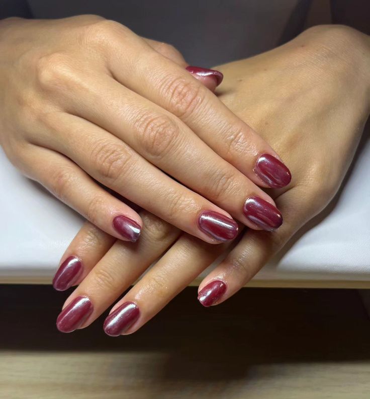 Elegant Burgundy Almond-Shaped Nails with Metallic Silver Accent and Glossy Finish.