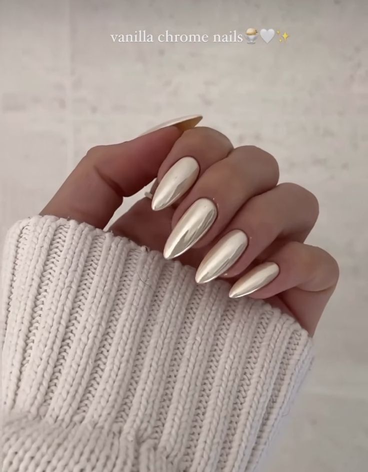 Modern Elegance: Stunning Vanilla Chrome Nails Complementing Cozy White Sweater.