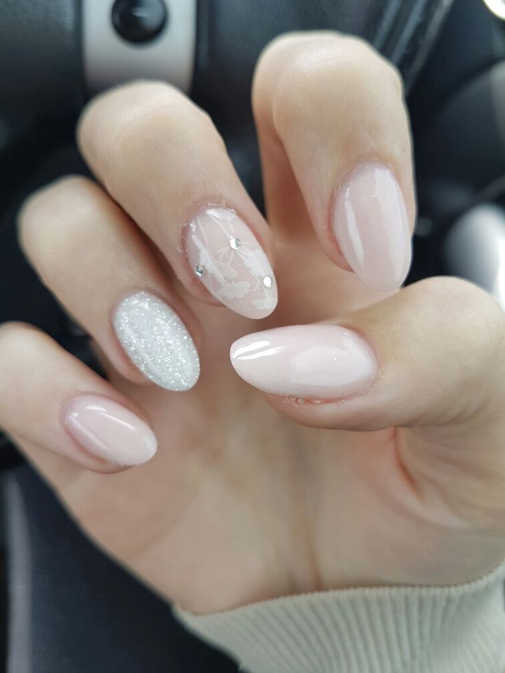 Sophisticated Elegant Nude Manicure with Glitter and Floral Accents