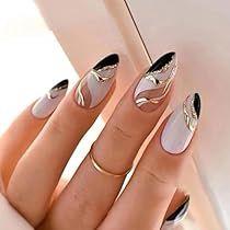 Sophisticated Chic Nail Design: Soft Pink and Black Tips with Elegant Gold Swirls.