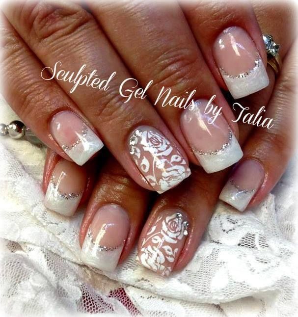 Elegant French Manicure with Intricate Floral Patterns and Silver Accents for Special Occasions