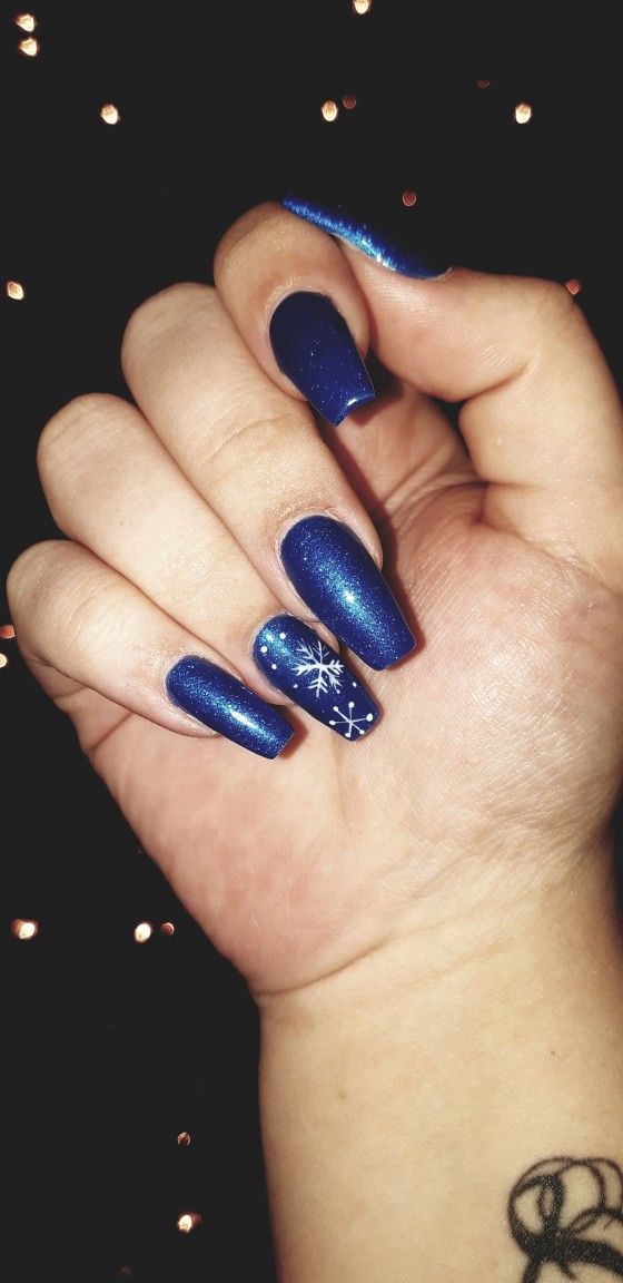 Elegant Winter Blue Nails with Shimmering Finish and Snowflake Accent.