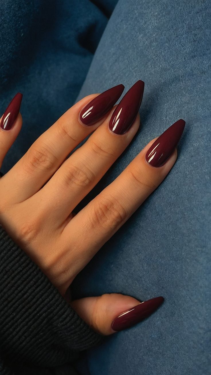 Sophisticated Almond-Shaped Burgundy Nails Perfect for Any Occasion.