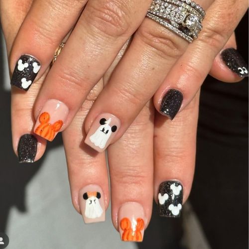 Playful Halloween-Inspired Nail Designs with Spooky Black and Glittery Finishes.