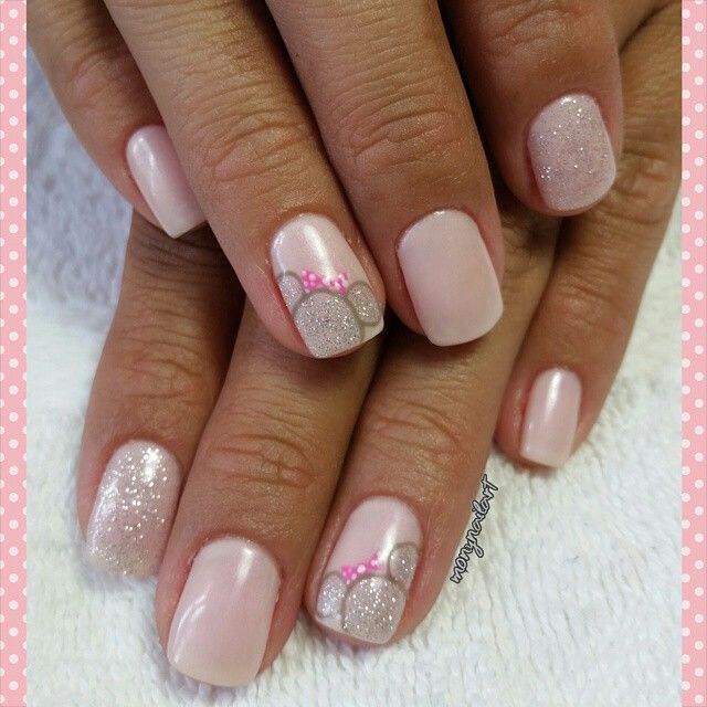 Whimsical Elegance: Soft Pink Nail Design with Glitter and Charming Accents