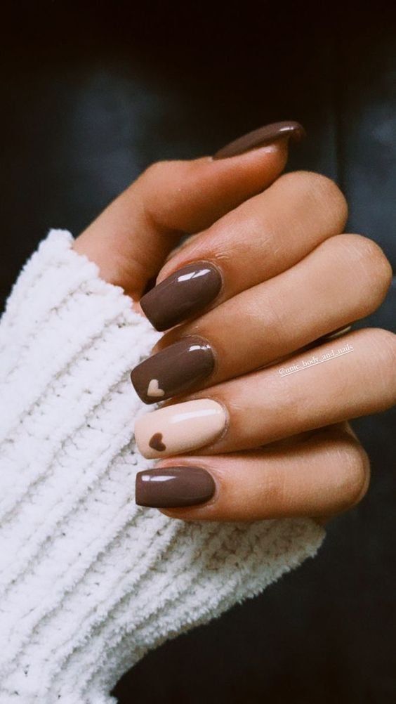 Chic Nail Design: Elegant Heart Motif in Deep Brown and Soft Beige.