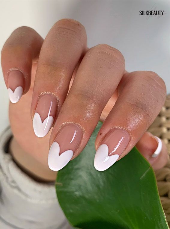 Whimsical Heart-Shaped Nail Design: Playful White Tips on a Natural Base.