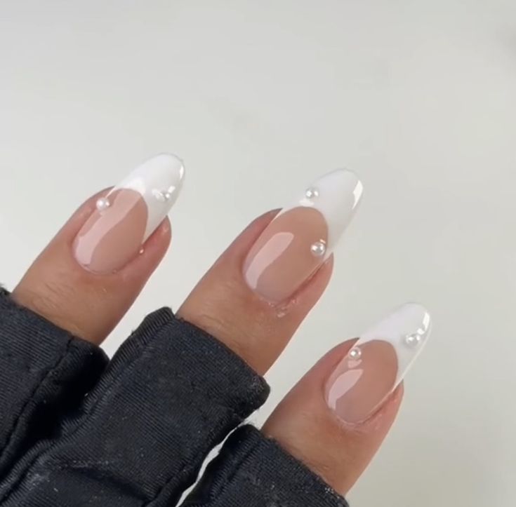 Chic French Tip Manicure: Elegant Almond Nails with Glossy Finish and Pearl Accents