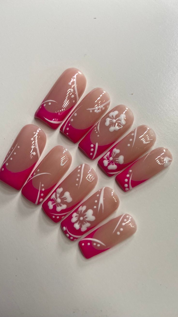 Elegant Nail Design: Soft Nude and Vibrant Pink with Floral Patterns and Delicate Line Work.