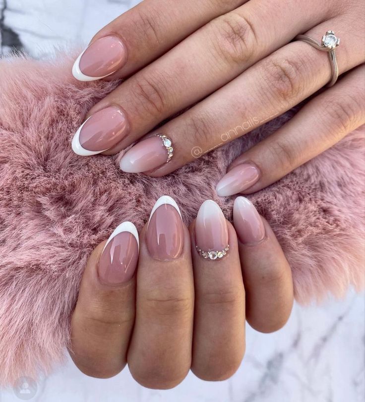 Elegant Nude and French Tip Nail Design with Rhinestones for Any Occasion.