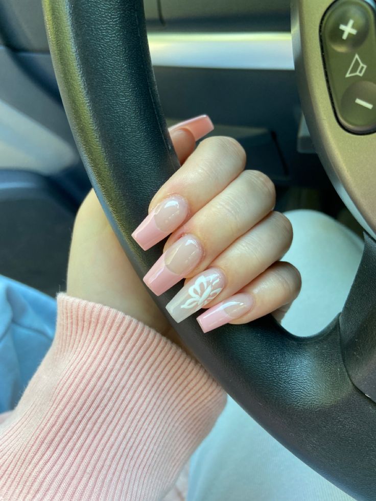 Elegant Nail Design: Soft Pink and Nude with Whimsical Floral Accents