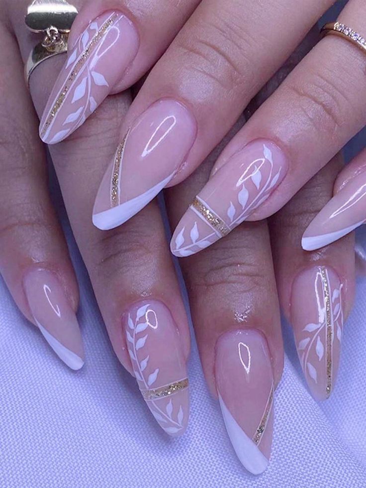 Sophisticated Floral Nail Design with White Leaf Patterns on Nude Base and Gold Accents