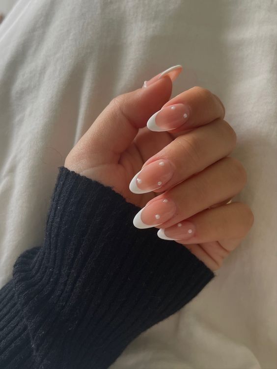 Sophisticated Elegant French Tip Nails with Blush Base and Charming Dot Details.