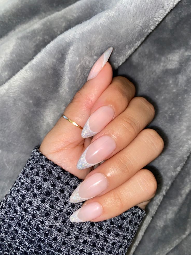 Chic Almond-Shaped Nail Design: Subtle Nude Base with Delicate Silver Accents.