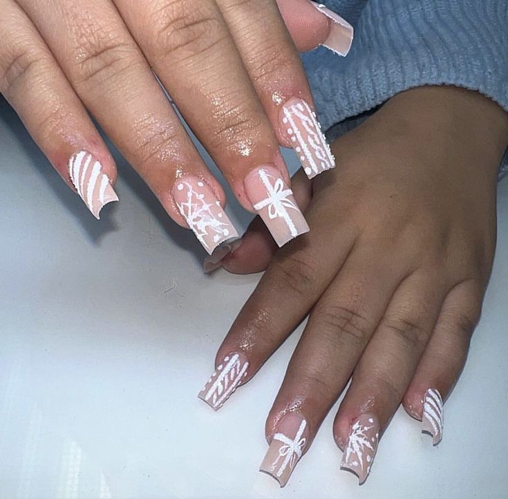 Sophisticated Soft Pink Nail Design with Intricate White Patterns