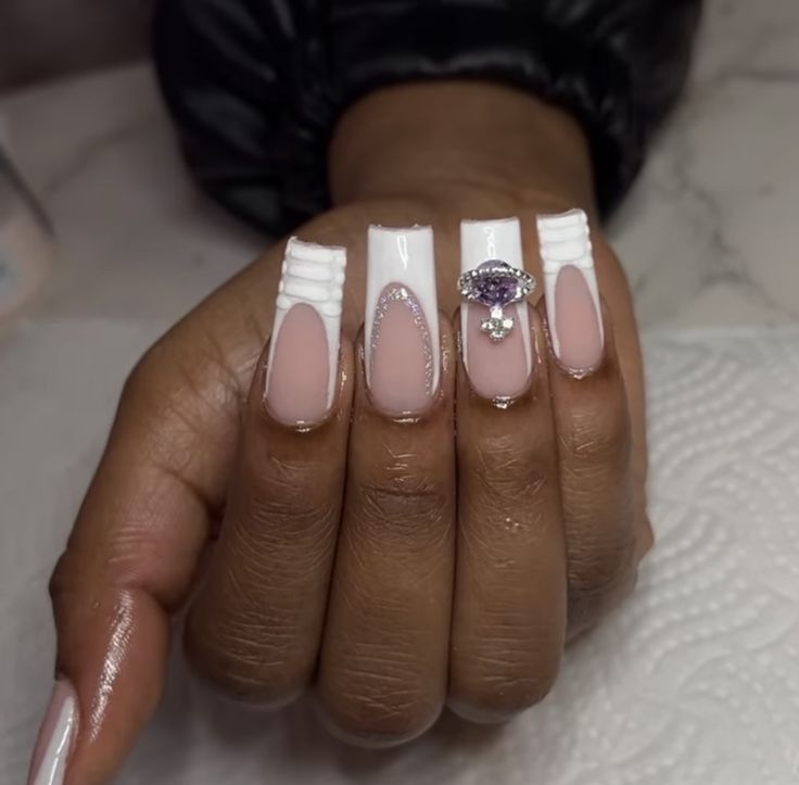 Glamorous Nail Design Blending Soft Pink and White with Intricate Textures and Sparkling Gemstone.