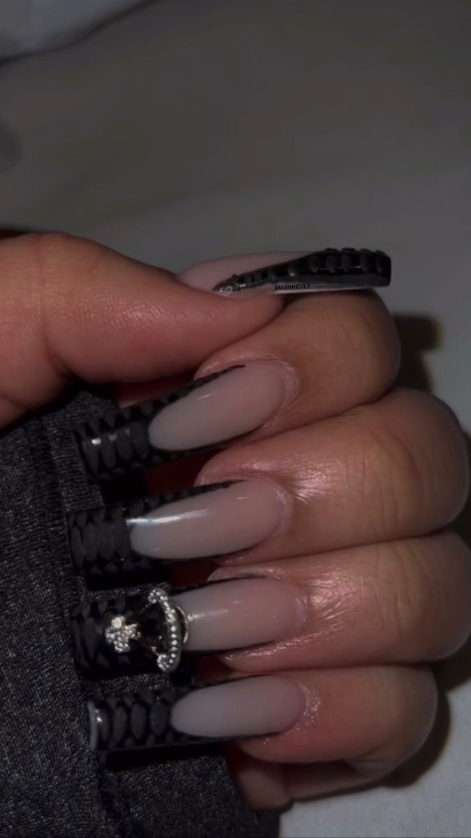 Chic Gradient Nail Design with Nude to Black Transition and Silver Accents.