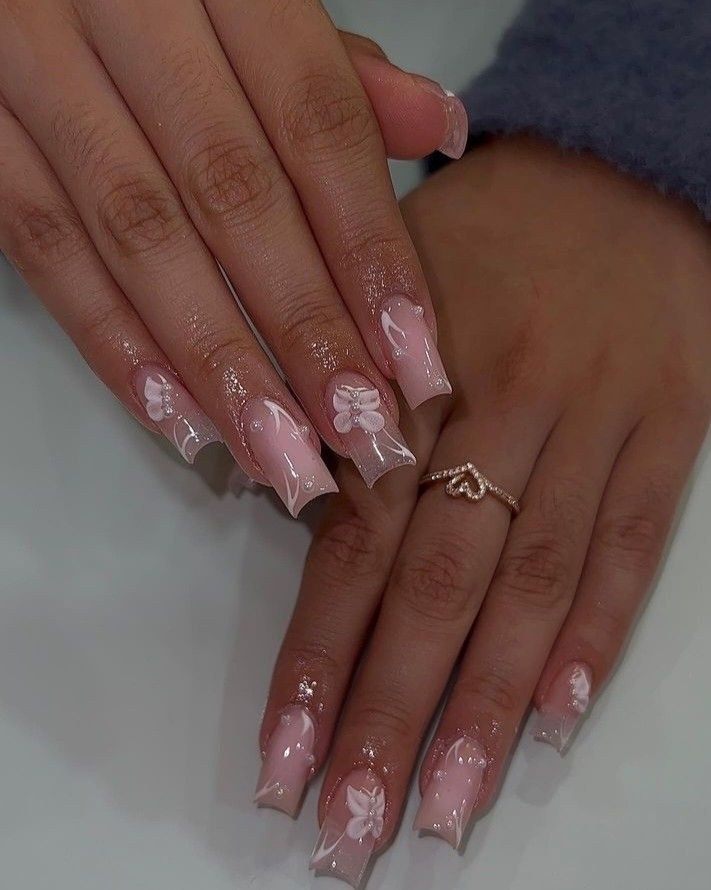 Elegant Floral Pink Nail Design with Glossy Finish and Subtle Glitter.