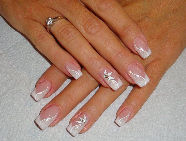 Sophisticated Classic French Tip Nail Design with Wavy White Accents and Delicate Floral Embellishments.