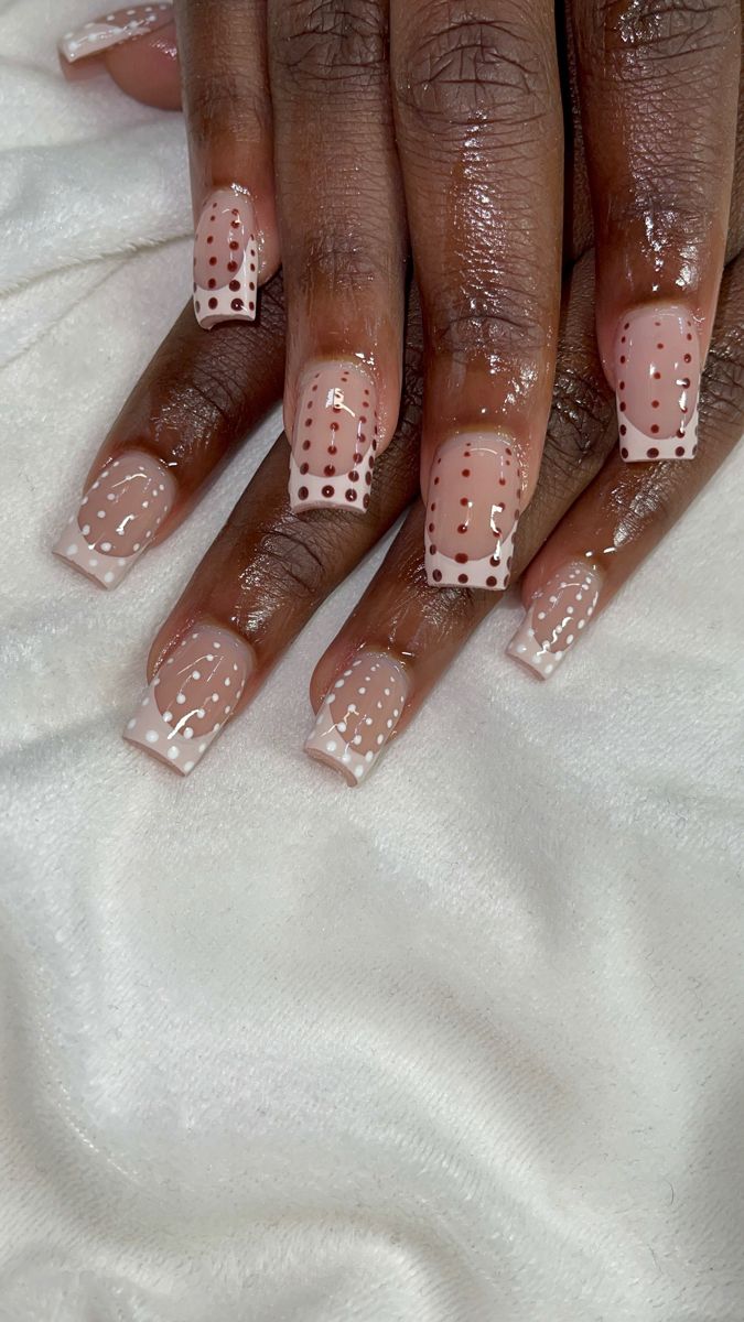 Chic Nude Nail Design with Intricate Dot Patterns and French Tip Accents.